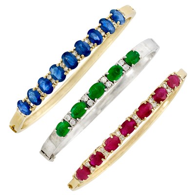 Lot 116 - Three Two-Color Gold Diamond, Sapphire, Emerald and Ruby Bangle Bracelets