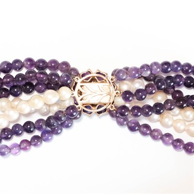 Lot 137 - Seven Strand Amethyst Bead and Cultured Pearl Torsade Necklace with Gold, Amethyst, Cabochon Emerald and Cultured Pearl Clasp