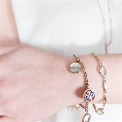 Lot 195 - Gold and Reverse Rock Crystal Intaglio Charm Bracelet, Long Low Karat Gold Fob Chain and Gold and Moonstone Bracelet