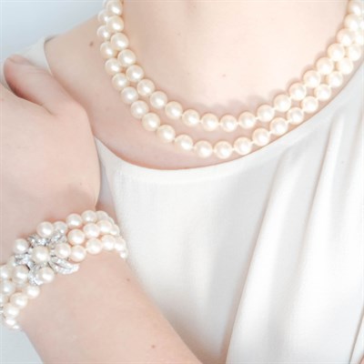 Lot 217 - Double Strand Cultured Pearl, White Gold and Diamond Necklace and Triple Strand Bracelet