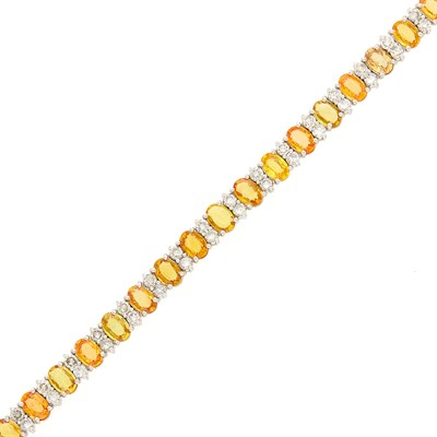 Lot 1163 - White Gold, Yellow and Orange Sapphire and Diamond Bracelet