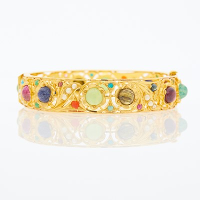Lot 1053 - Gold, Cabochon Colored Stone and Split Pearl Bangle Bracelet