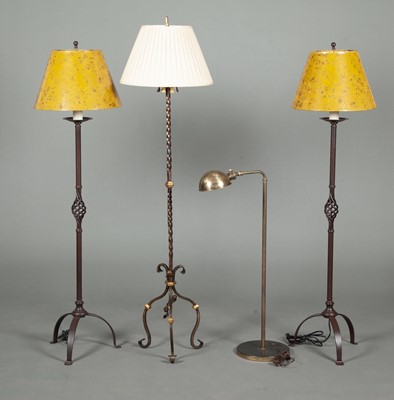 Lot 334 - Three of Patinated Metal Tripod Floor Lamps