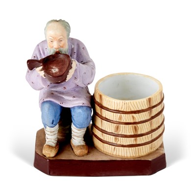 Lot 681 - Russian Porcelain Figure of a Man Drinking from a Barrel