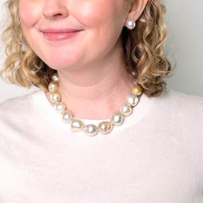 Lot 1083 - South Sea and Golden Baroque Cultured Pearl Necklace, Attributed to Maja DuBrul, and Pair of Earclips