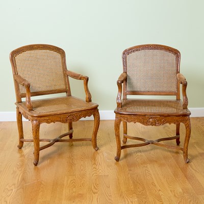 Lot 128 - Pair of Régence Caned and Carved Walnut Fauteuils