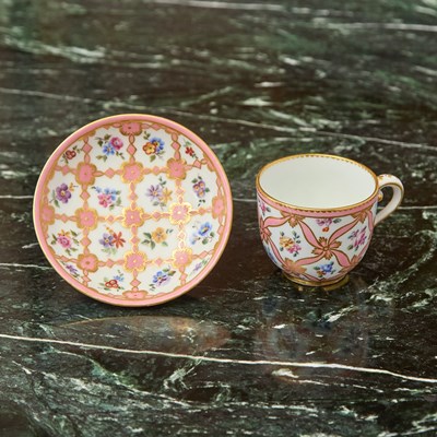 Lot 441 - SEVRES PORCELAIN SALMON-PINK TRELLIS GROUND SMALL CUP AND A SAUCER (GOBELET BOUILLARD, EME GRANDEUR)