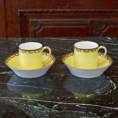 Lot 527 - TWO SEVRES PORCELAIN YELLOW-GROUND CUPS AND SAUCERS (GOBELET LITRON)