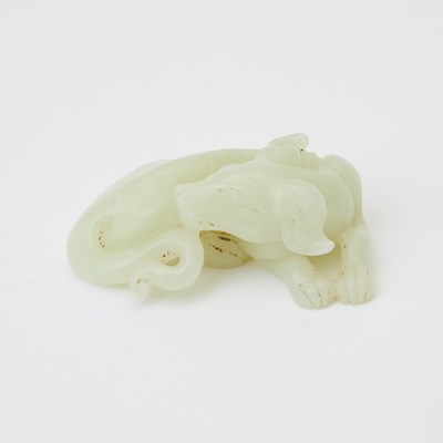 Lot 28 - A Chinese Celadon Light Jade Carving of a Hound