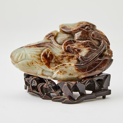 Lot 24 - A Chinese Mottled Brown and Celadon Jade Carving