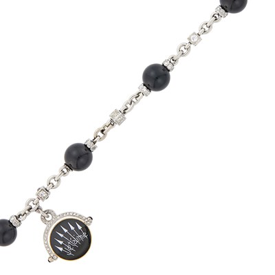 Lot 1055 - Platinum, Gold, Black Onyx Bead, Enamel and Diamond 'Je t'aime' Charm Bracelet