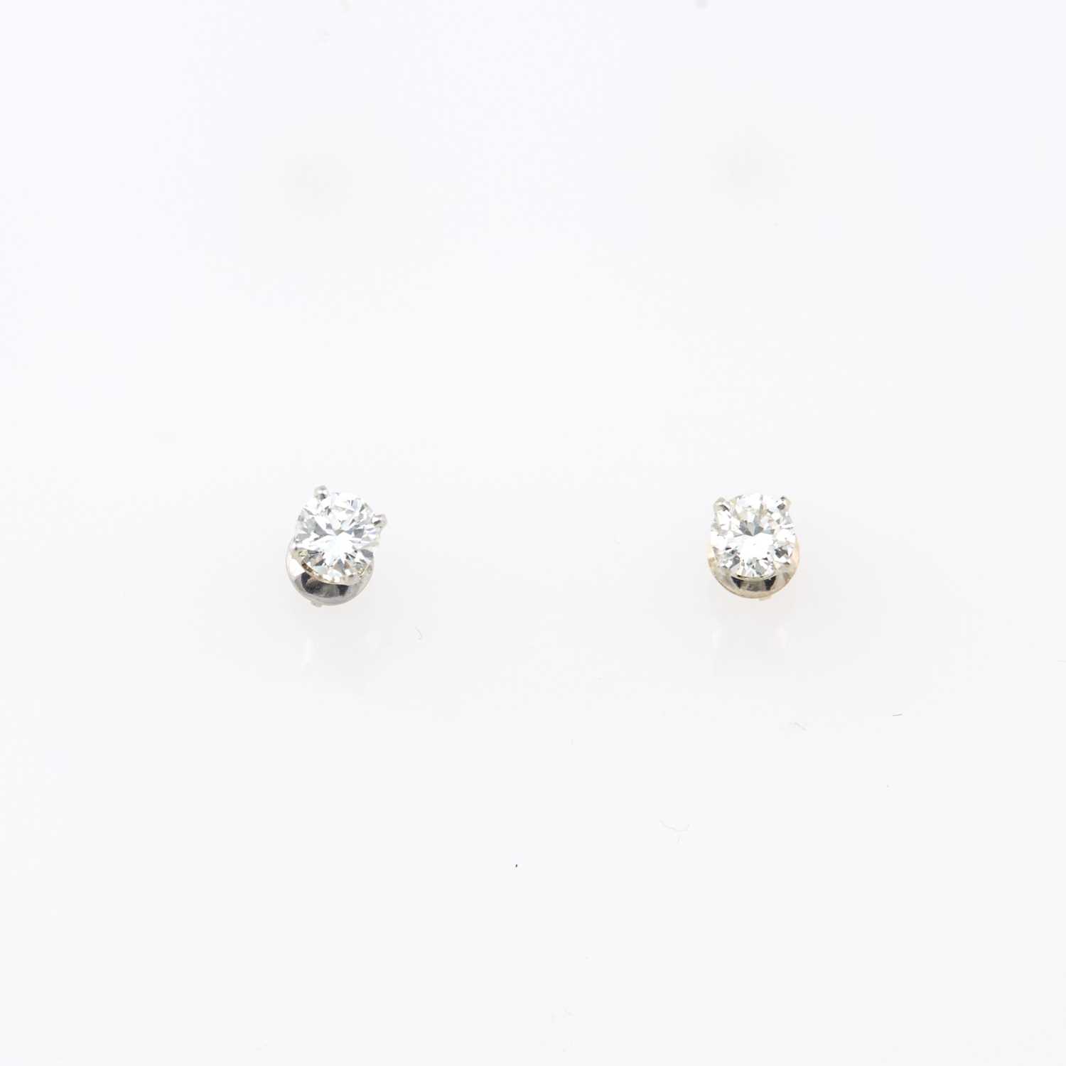 Lot 158 - Two Diamond Solitaire Earrings about 0.90 ct., 14K 1 dwt.