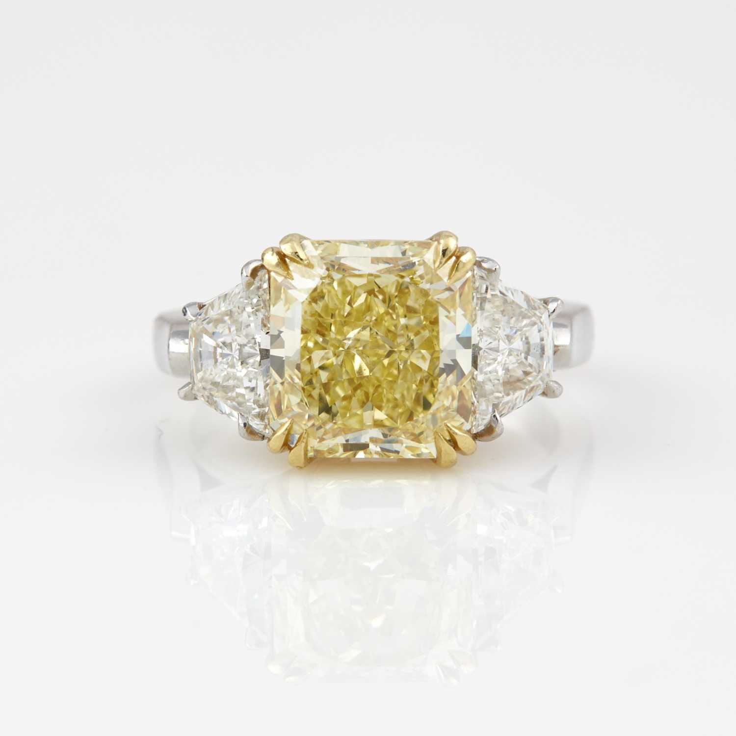 Lot 281 - Diamond Engagement Ring, 3 diamonds, center stone about 4.41 cts. Natural Fancy Yellow, Platinum and18K 5 dwt. with copy of GIA Report #21052973