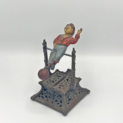 Lot 238 - Painted Cast Iron "Boy on Trapeze" Mechanical Bank