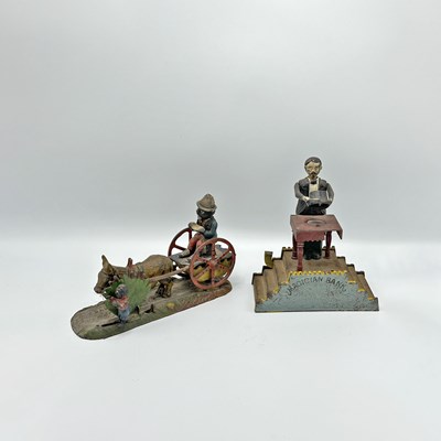 Lot 241 - Painted Cast Iron "Magician Bank" and "Bad Accident" Mechanical Banks