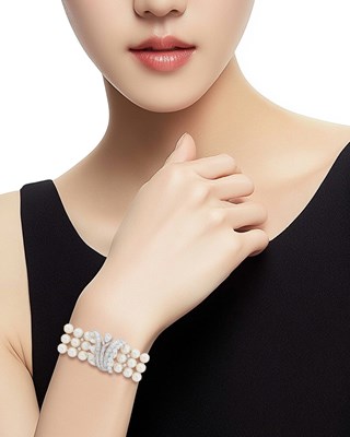 Lot 151 - Triple Strand Cultured Pearl, Platinum and Diamond Bracelet