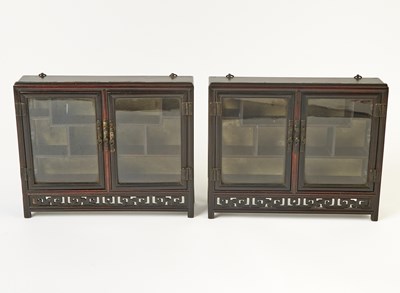 Lot 606 - A Pair of Chinese Hardwood Collector’s Cabinets