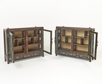 Lot 606 - A Pair of Chinese Hardwood Collector’s Cabinets