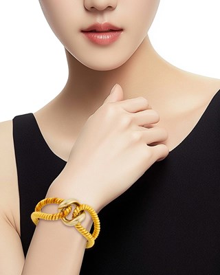 Lot 25 - Two-Color Gold Bangle Bracelet