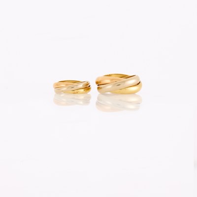 Lot 1034 - Cartier Two Tricolor Gold 'Trinity' Band Rings, France
