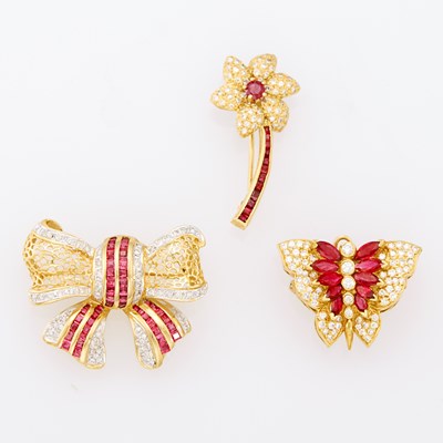 Lot 1059 - Three Two-Color Gold, Ruby and Diamond Flower, Bow and Butterfly Brooches
