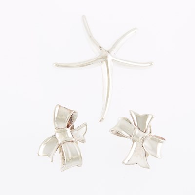 Lot 1299 - Angela Cummings Pair of Silver Bow Earclips and Tiffany & Co. Silver Starfish Brooch