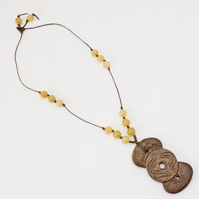 Lot 519 - A Chinese Mottled Jade Carving of a Pendant