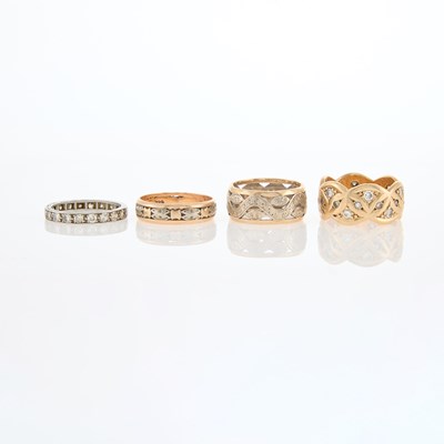 Lot 222 - Four Two-Color Gold, Platinum and Diamond Band Rings