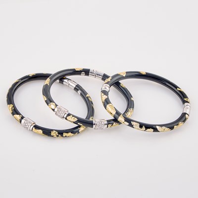 Lot 241 - Three Diamond, Plastic and Enamel Rigid Bracelets, 48 diamonds about 0.50 ct., 18K 34 dwt. all
