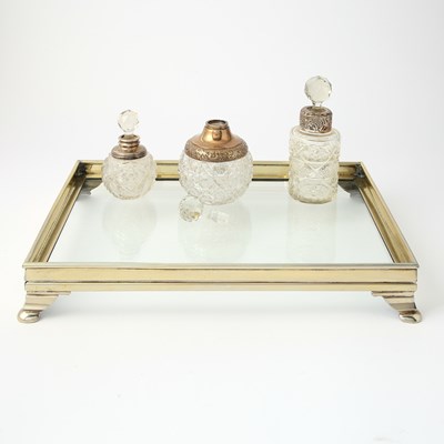Lot 112 - Three Silver-Mounted Cut-Glass Stoppered Perfume Bottles on a Silver-Plated Glass-Bottom Tray