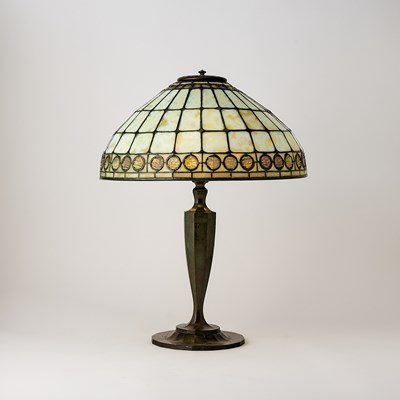 Lot 678 - Tiffany Studios Bronze and Leaded Glass ‘Colonial Faux-Jeweled Band’ Table Lamp