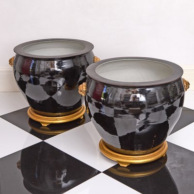 Lot 141 - Large Pair of Chinese Black Glazed Porcelain Planters with Gilt Lion's Masks on Giltwood Stands