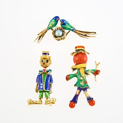 Lot 1050 - Three Gold, Enamel, Coral and Gem-Set Lovebird, Scarecrow and Clown Brooches