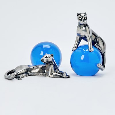 Lot 3358 - Two Cartier Sterling Silver and Cobalt Blue Glass "Panther and Ball" Table Ornaments
