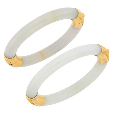 Lot 1105 - Two Light Green Jade and Gold Bangle Bracelets
