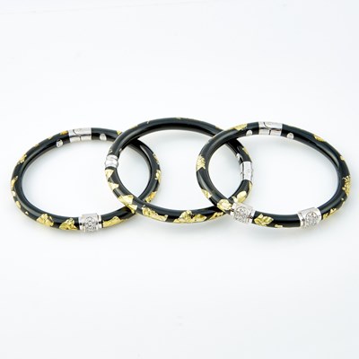 Lot 498 - Three Diamond, Plastic and Enamel Rigid Bracelets, 48 diamonds about 0.50 ct., 18K 34 dwt. all