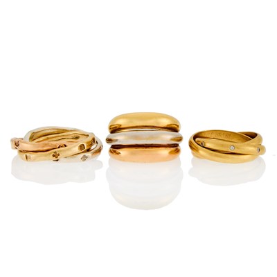 Lot 1244 - Two Tricolor Gold and Diamond Rolling Band Rings and Band Ring