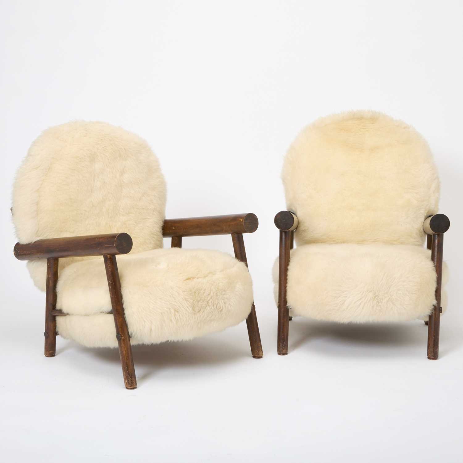 Lot 236 - Pair of After Charlotte Perrriand Sheepskin Upholstered Stained Beechwood Chalet Armchairs
