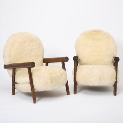Lot 236 - Pair of After Charlotte Perrriand Sheepskin Upholstered Stained Beechwood Chalet Armchairs