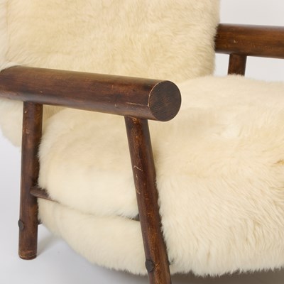 Lot 236 - Pair of After Charlotte Perrriand Sheepskin Upholstered Stained Beechwood Chalet Armchairs