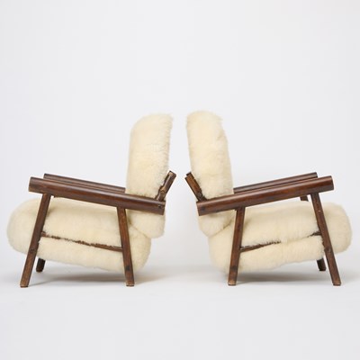 Lot 236 - Pair of After Charlotte Perrriand Sheepskin Upholstered Stained Beechwood Chalet Armchairs