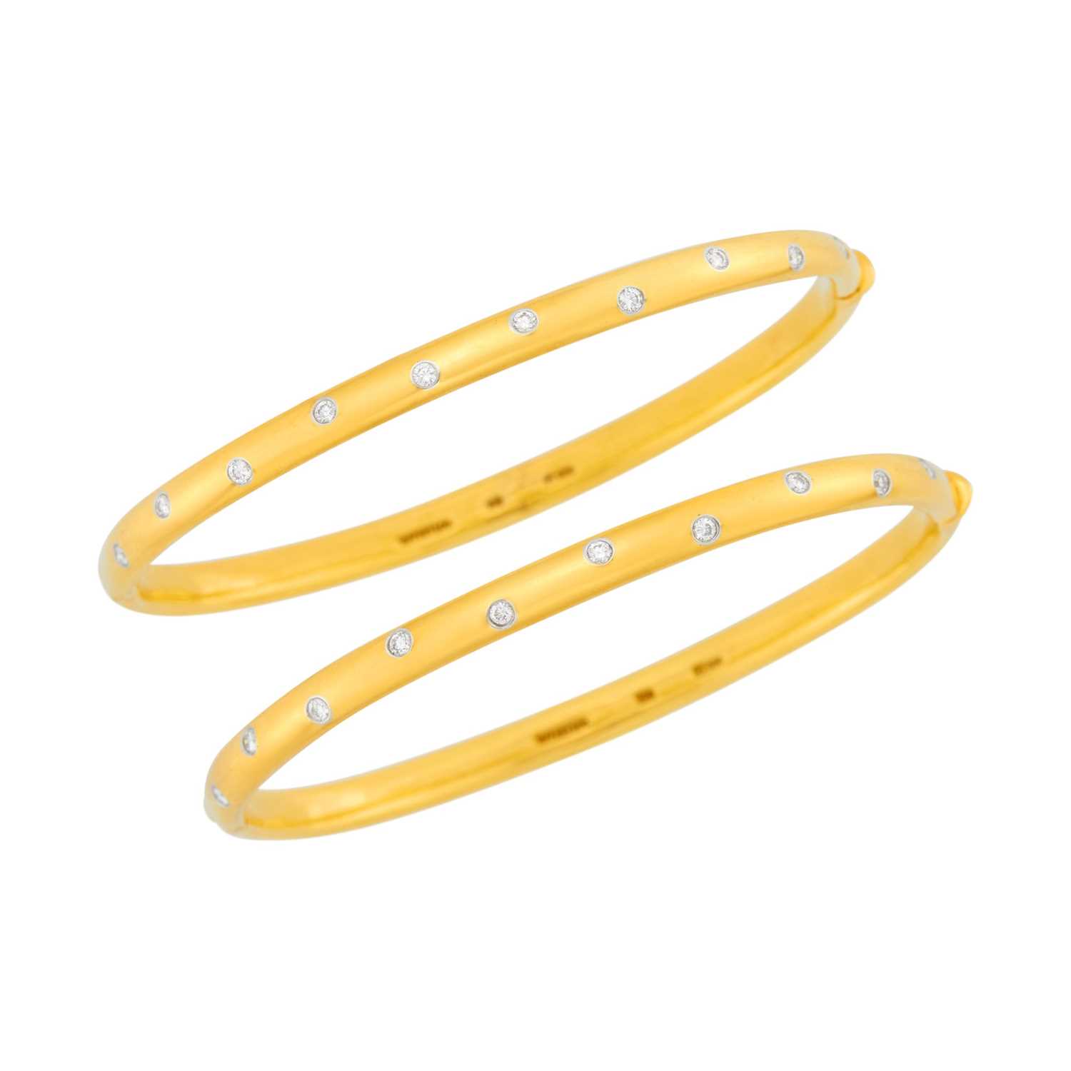 Lot 1002 - Tiffany & Co. Pair of Gold, Platinum and Diamond 'Etoile' Bangle Bracelets