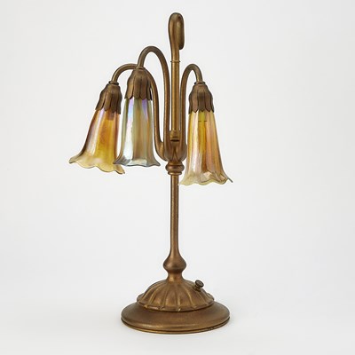 Lot 260 - Tiffany Studios Gilt-Bronze and Favrile Glass Three-Light Pond Lily Table Lamp
