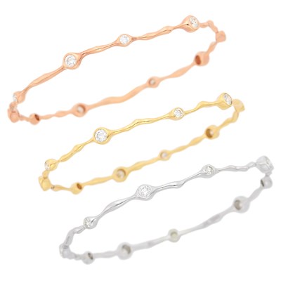 Lot 40 - Three Yellow, White and Rose Gold and Diamond Bangle Bracelets