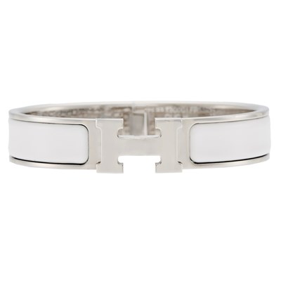 Lot 1287 - Hermès Gilt Metal, White Enamel 'Clic H' Bangle Bracelet