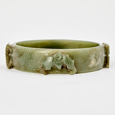 Lot 48 - A Chinese Carved Green Jade Bangle