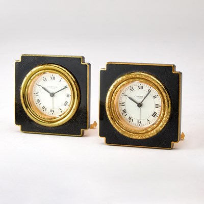 Lot 190 - Pair of Cartier Gilt Metal and Black Enamel Travel Clocks