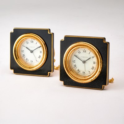 Lot 189 - Pair of Cartier Gilt Metal and Black Enamel Travel Clocks