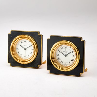 Lot 187 - Pair of Cartier Gilt Metal and Black Enamel Travel Clocks