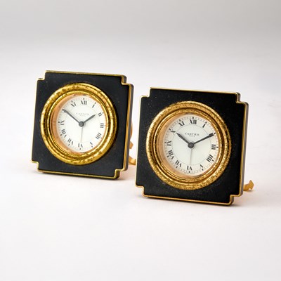 Lot 186 - Pair of Cartier Gilt Metal and Black Enamel Travel Clocks
